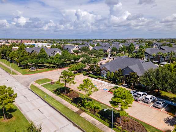 A residential area with houses and a parking lot at Avenues at Shadow Creek Ranch Apartments, Pearland, TX