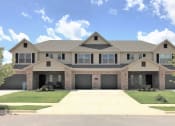 Thumbnail 3 of 60 - Building Exterior from the front showing attached garages and front doors