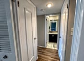 Thumbnail 6 of 28 - a hallway view of a bathroom