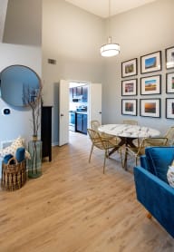 a living room and dining room with a table and chairs