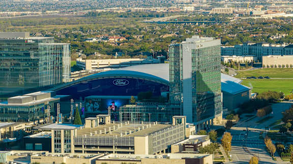 A modern building with a glass facade is the focal point of the image.