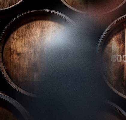 the barrels of a wine cellar with the logo of droppers row on it
