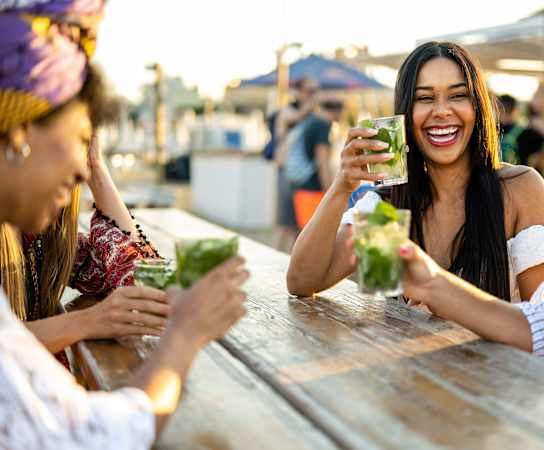 a group of people sitting at a table with drinks at Glenwood at Grant Park Apartments, Atlanta, 30316