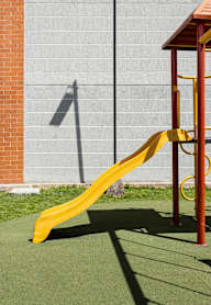A yellow slide in a playground.