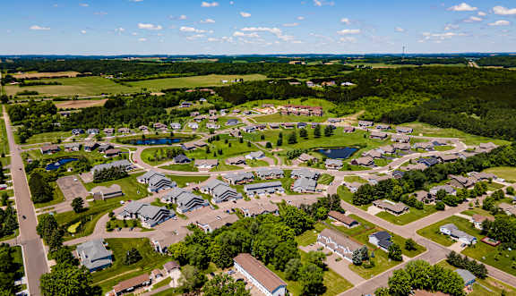 A bird's eye view of a residential neighborhood with houses and greenery.
