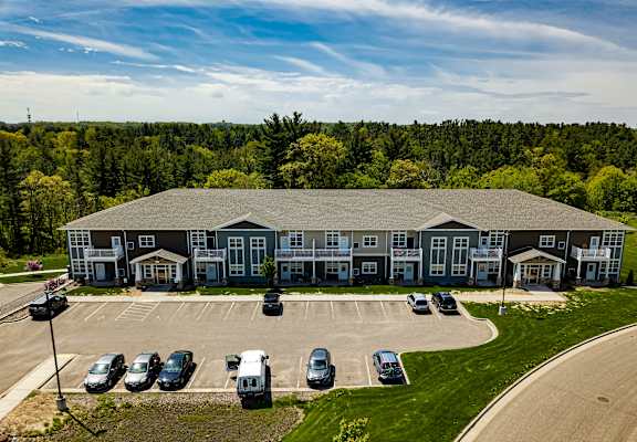 A large building with a parking lot in front of it.