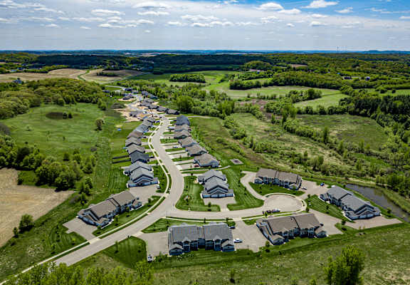 A bird's eye view of a residential area with houses and greenery.