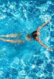 A person swimming in a pool.