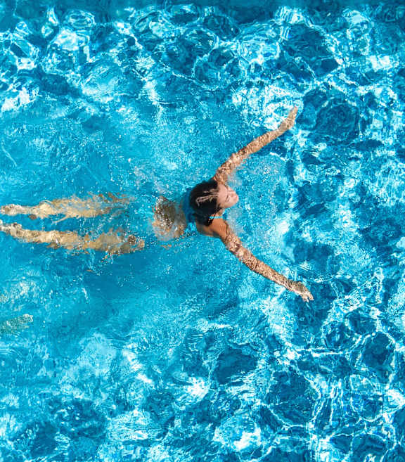 A person swimming in a pool.