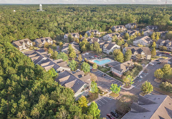 a birdseye view of a neighborhood with houses and a swimming pool