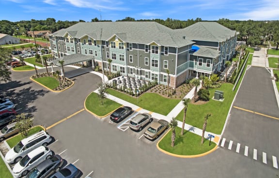 an aerial view of a large building with cars parked in front of it