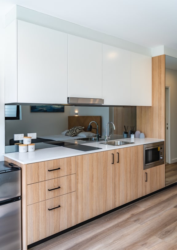 a kitchen with white cabinets and a counter top and a sink