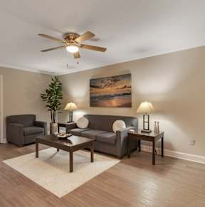 a bedroom with a bed and a ceiling fan