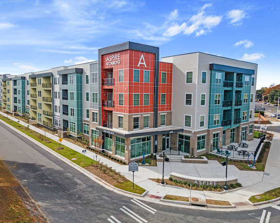 an exterior view of an apartment building on a city street