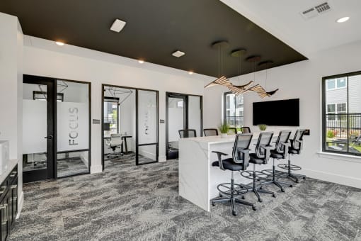 an open concept office with a white reception desk and black ceiling  at Prism at Diamond Ridge, Moon Township