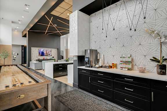 a large kitchen with black cabinets and a wooden table at Prism at Diamond Ridge, Moon Township, PA, 15108