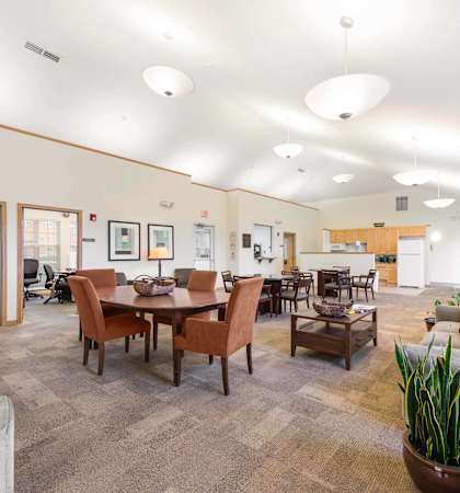a living room with couches and chairs and a dining room table
