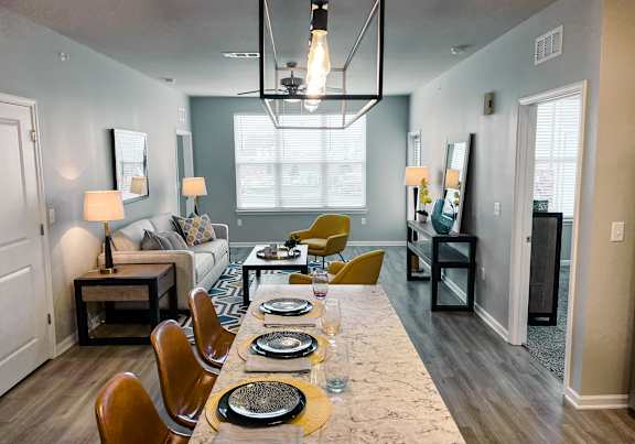 A dining room with a long table set for a meal.