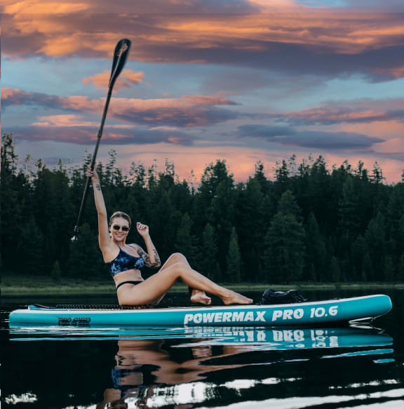 a woman on a paddle board on a lake Lewisville