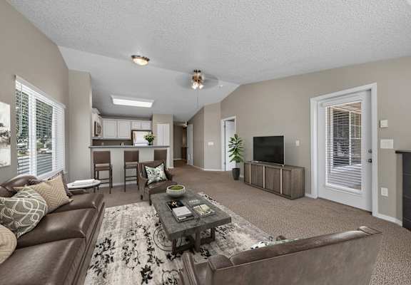 A living room with a brown leather couch and a coffee table.