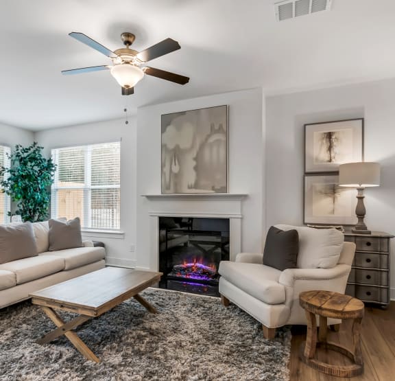 a living room with couches and a coffee table and a fireplace