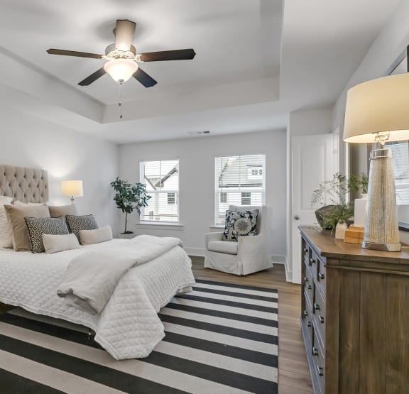 a bedroom with a bed and a ceiling fan
