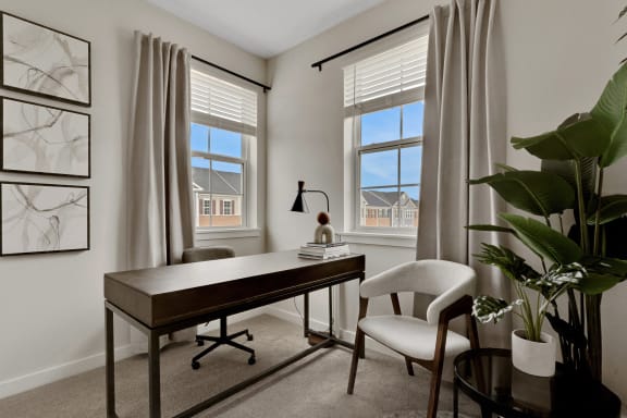a view of a living room with couches and a table at The Retreat at Brandywine Crossing, Brandywine, MD 20613