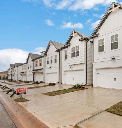 a row of white houses on the side of a street