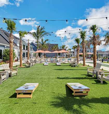 a grassy area with picnic tables and chairs at The Sophia, Venice, FL, 34275