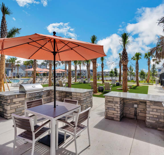 an outdoor patio with tables and chairs and umbrellas  at The Sophia, Venice, Florida