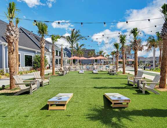 a grassy area with picnic tables and chairs at The Sophia, Venice, FL, 34275