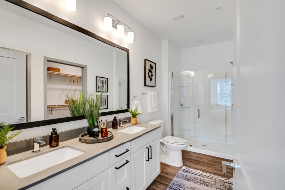 a bathroom with a large mirror and a toilet and a shower at The BLVD at Wilson Crossings, Wyoming, 49418