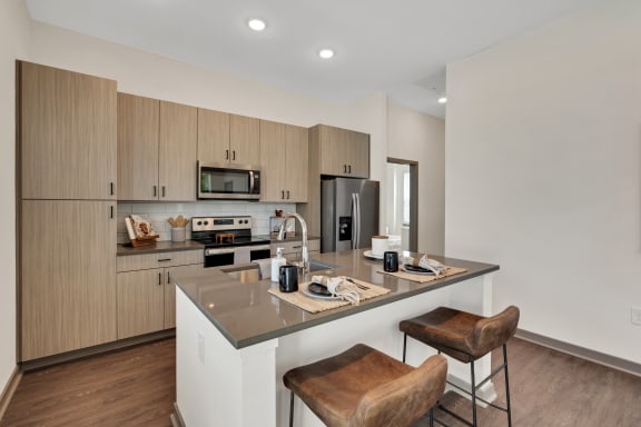 a kitchen with a large island with two stools  at The Sophia, Florida, 34275