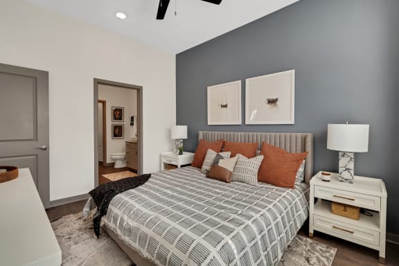 a bedroom with grey walls and a bed with pillows  at The Sophia, Florida, 34275