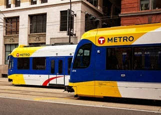 A blue and yellow train with the word Metro on it.