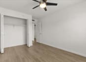 Thumbnail 10 of 11 - an empty bedroom with a ceiling fan and a closet