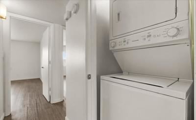a white kitchen with a washer and dryer in it