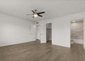 Thumbnail 8 of 11 - an empty living room with a ceiling fan