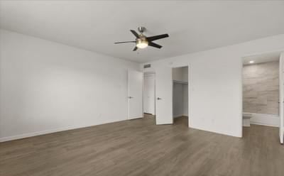 an empty living room with a ceiling fan