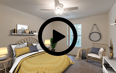 a bedroom with a bed and a ceiling fan with a video play button in the middle of