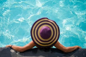 Woman With Hat Relaxing In Pool at Link Apartments® Brookstown, Winston Salem