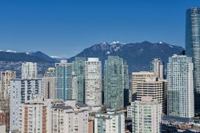 a view of the city of vancouver with mountains in the background