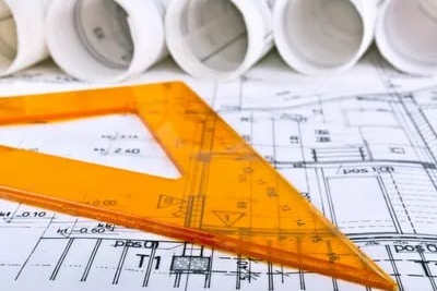 a bunch of architectural plans with a ruler on top of them
