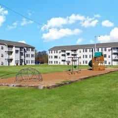 a playground in front of an apartment building