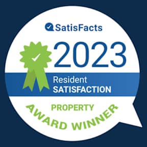 A badge indicating a property award winner for resident satisfaction in 2023.