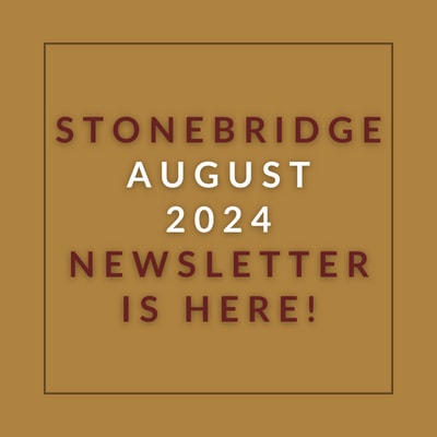 a red wall with a sign that saysstonebridge apartment homes may 23 23 newsletter is here