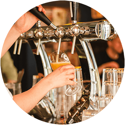 A person is pouring a beer from a tap.