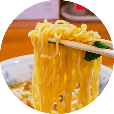 A plate of noodles with chopsticks.