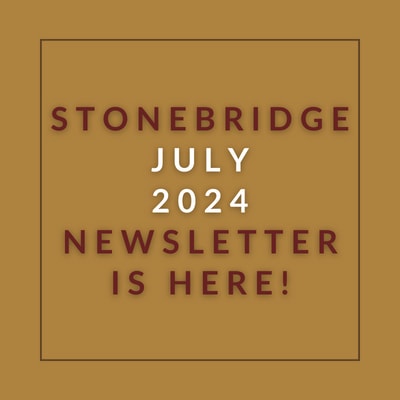 a red wall with a sign that saysstonebridge apartment homes may 23 23 newsletter is here
