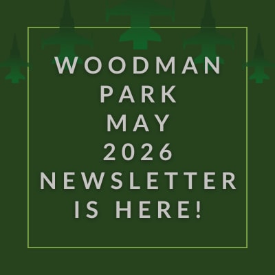 A black background with a green border and text that reads "Woodman Park December 2024 Newsletter is here!".